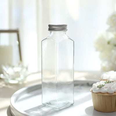 Clear glass bottle with a silver lid on a tray.