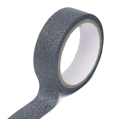 Black glitter washi tape on a roll for crafting and decorating.