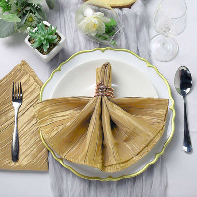 Elegant gold napkin tied with a ring on a beautifully set dining table.