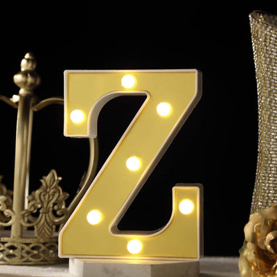 Yellow marquee letter Z with lights on a dark background.