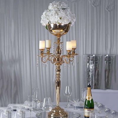 Elegant gold candelabra centerpiece with flowers and candles for events.