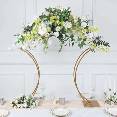 Floral arch centerpiece with white and yellow flowers on a gold stand