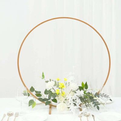 Geometric floral centerpiece with greenery and white flowers in a modern setting.