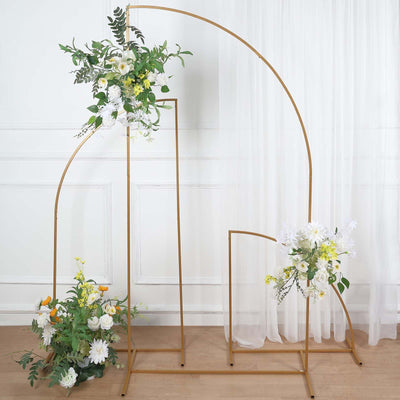 Gold floral arch with white and yellow flowers against a draped backdrop.