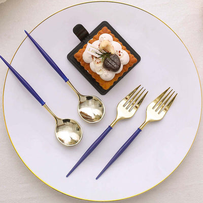Elegant gold and blue cutlery with a dessert on a white plate.