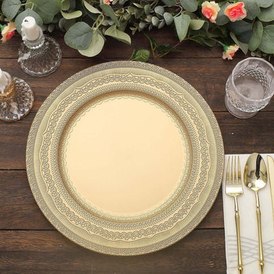Gold decorative charger plate on a wooden table with cutlery and glassware.