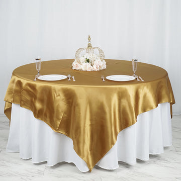 Elevate Your Event with the Gold Seamless Satin Square Table Overlay