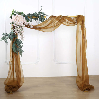 Elegant wedding arch with draped fabric and floral accents