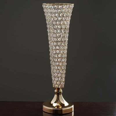 Elegant gold and crystal vase with a conical design.