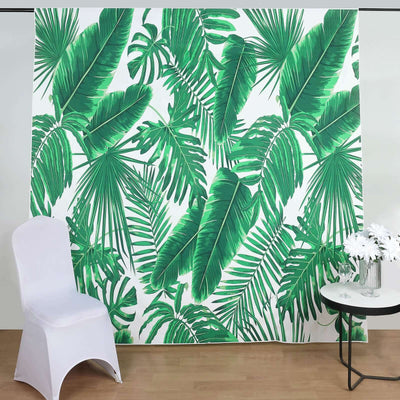Tropical green leaf backdrop with white chair and table
