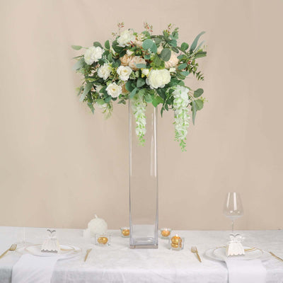 Elegant floral centerpiece in a tall glass vase for wedding decor.