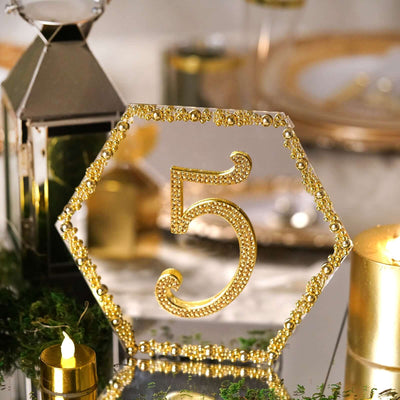 Gold hexagon table number 5 with rhinestones for elegant events and decorations.
