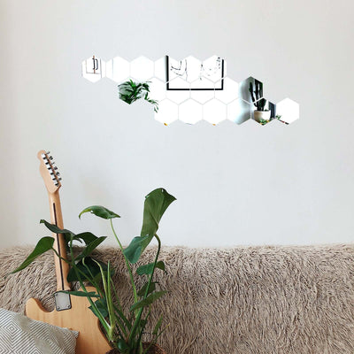 Hexagon mirror wall decor with plants and guitar in a cozy living room setting.