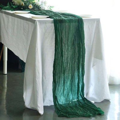 Green textured table runner draped on a white table.