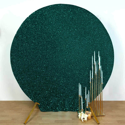 Teal glitter backdrop with gold candle holders and white candles.