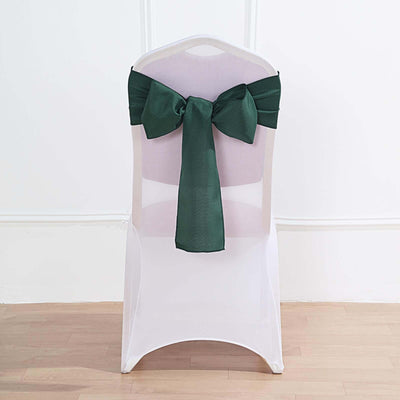 Green chair sash tied in a bow on a white chair.