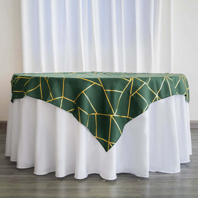 Green tablecloth with yellow geometric pattern draped over a white table.