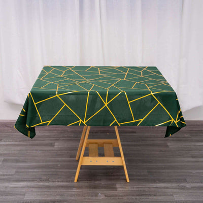 Green geometric tablecloth with yellow lines on a wooden table.