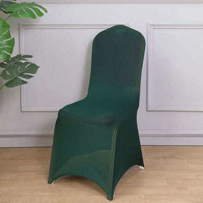 Green transparent chair on a light wooden floor with decorative plant