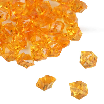 Amber crystal gemstones scattered on a white background