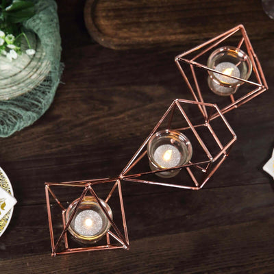Rose gold geometric candle holders with tealight candles.