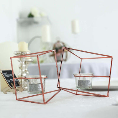 Rose gold geometric candle holders with glass containers.