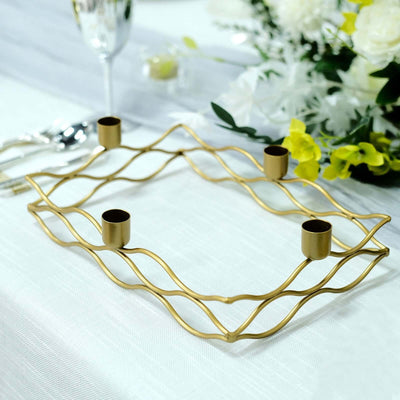 Elegant gold candle holder with wavy design and four candle cups.