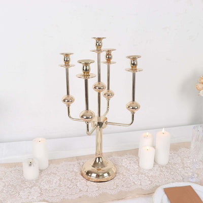 Gold candelabra with multiple candle holders on a table