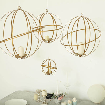 Set of gold spherical candle holders in various sizes hanging decoratively.