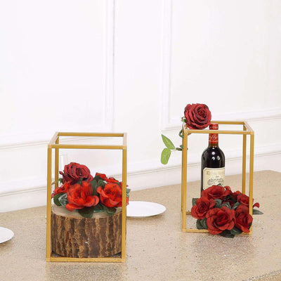 Decorative flower arrangements in gold wire frames with red roses.