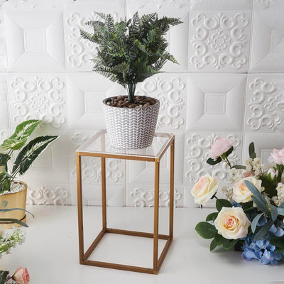 Decorative plant in a pot on a modern gold metal stand