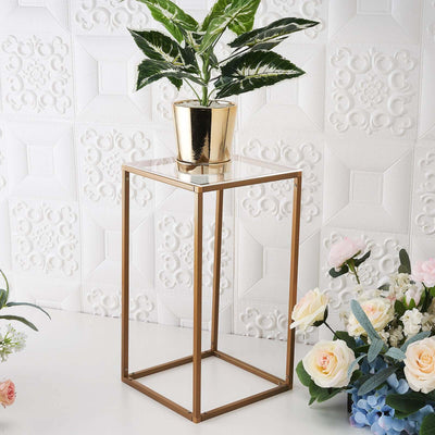 Gold metal plant stand with glass top and decorative plant