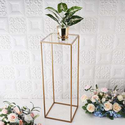 Gold plant stand with a potted plant on top, surrounded by flowers.