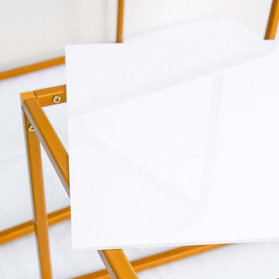 White tabletop with gold metal frame, studio shot