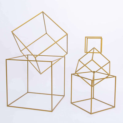 Geometric gold wire sculptures in various sizes on a white background