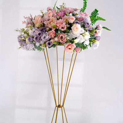 Elegant floral arrangement in pastel colors on a gold stand.