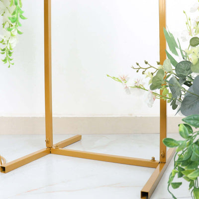 Gold metal plant stand with floral accents