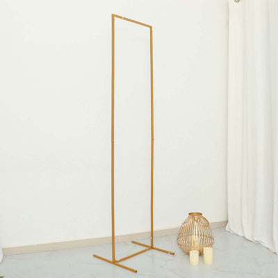Gold standing mirror frame on a white backdrop.