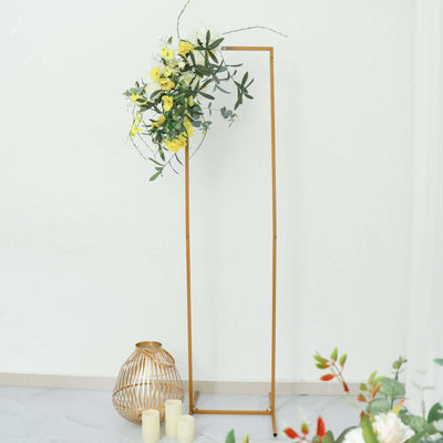 Elegant gold flower stand with floral arrangement and decorative elements.