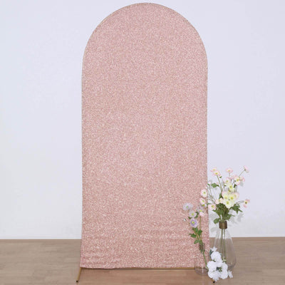 Rose gold sequin backdrop with arched top and flowers in a vase