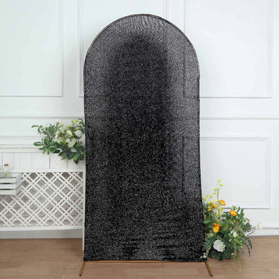 Black textured backdrop with arch shape for photography.