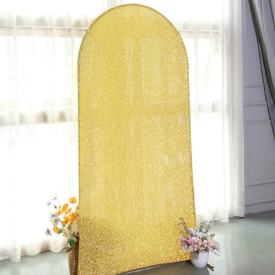 Gold glitter backdrop for photography with floral arrangement.