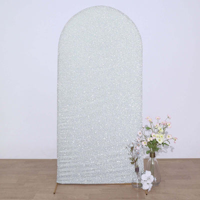 Glittery arch backdrop with floral arrangement in a vase