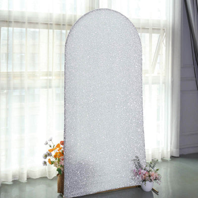 Sparkling silver arch mirror with a floral arrangement