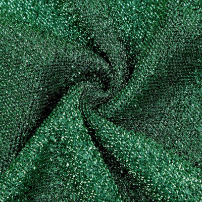 Textured green fabric swirl close-up for textile design and fashion applications.