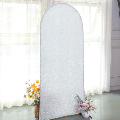 Sparkling arch mirror with floral arrangements in a bright interior setting.
