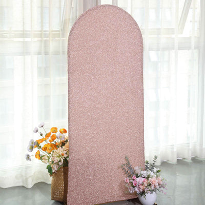 Rose gold glitter backdrop with floral arrangements in a studio setting.