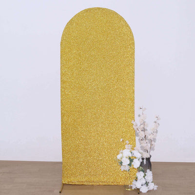 Gold glitter photo backdrop with floral arrangement.