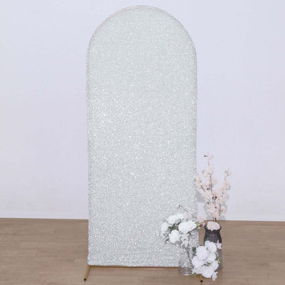 Silver glitter arch backdrop with floral arrangement