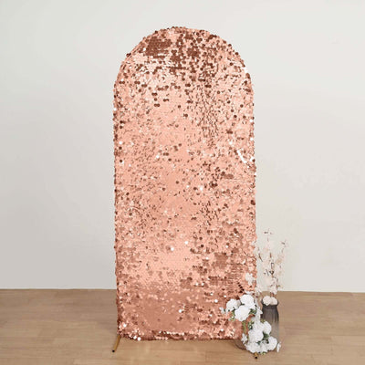 Rose gold sequin backdrop with an arch shape, ideal for events and photo shoots.